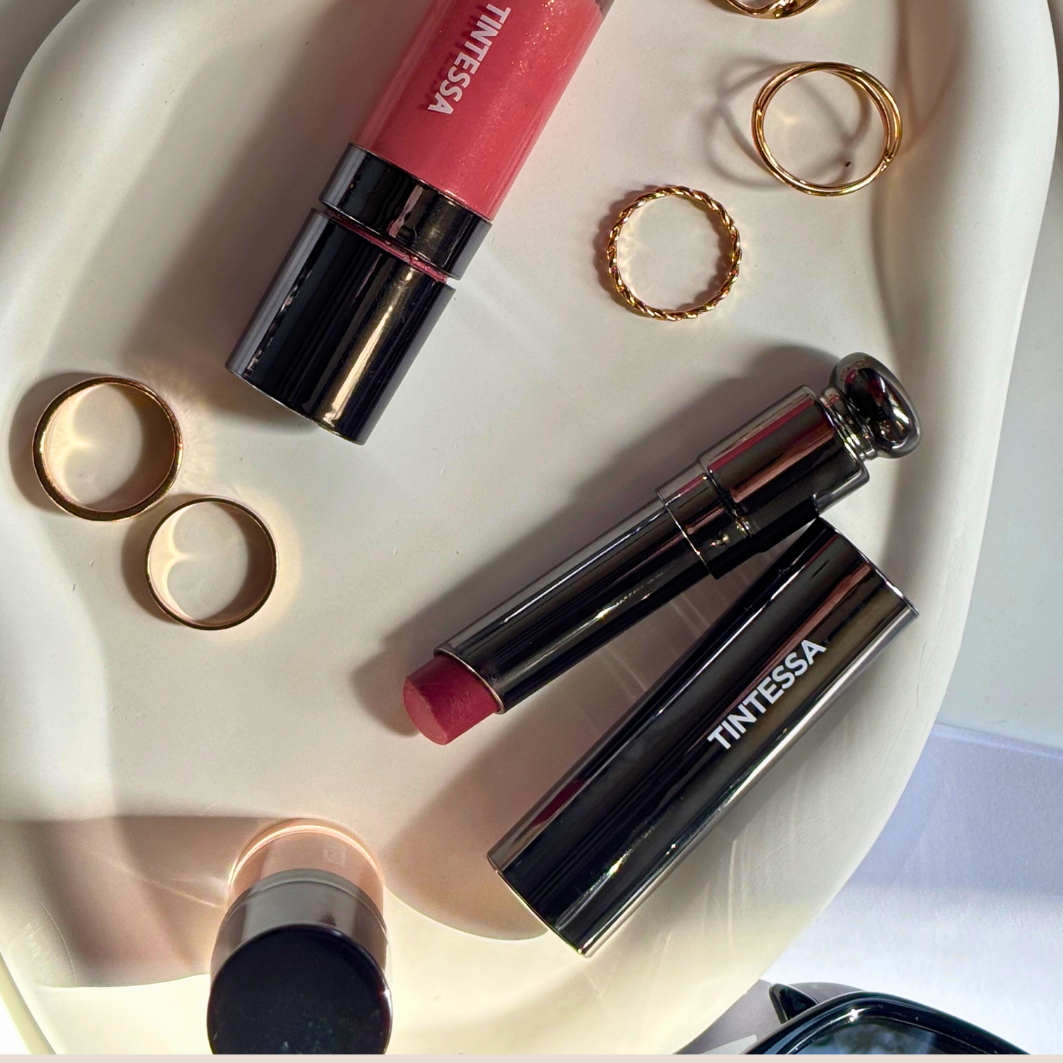 Flat lay of Tintessa's skincare supercharged range: lip butter and mousse tint