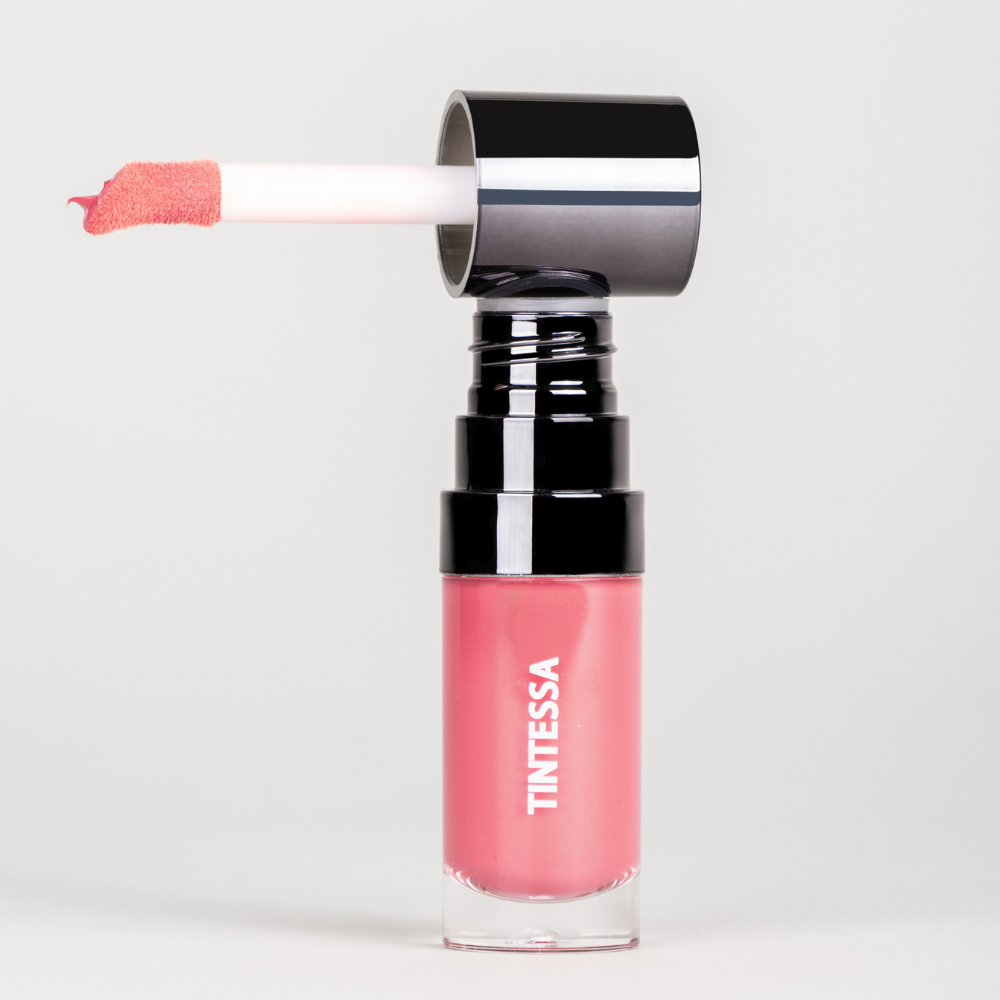 Cheek, lips and lids multi-use tint in rosy pink colour with applicator on a white background