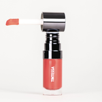 Cheek, lips and lids multi-use tint in red colour with applicator on a white background