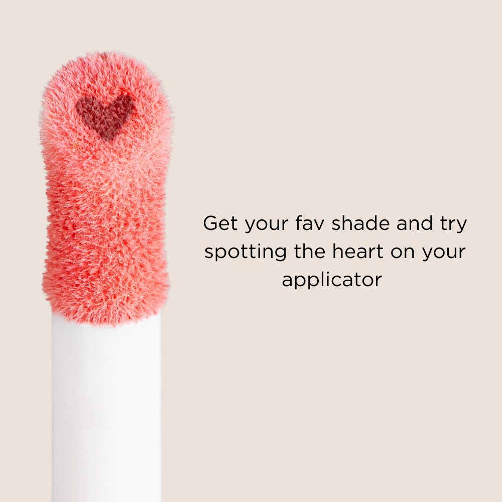Blush applicator with heart design on a beige background